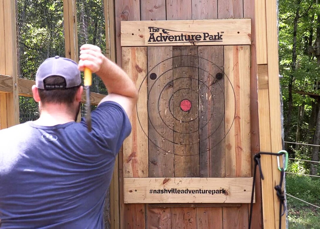 Allen Malcomb, U.S. Army Corps of Engineers Nashville District civil engineer, lines up his throw in hopes of hitting a bullseye and helping his team win the ax throwing competition during his final LDP II challenge at the Adventure Park in Nashville, Tennessee.