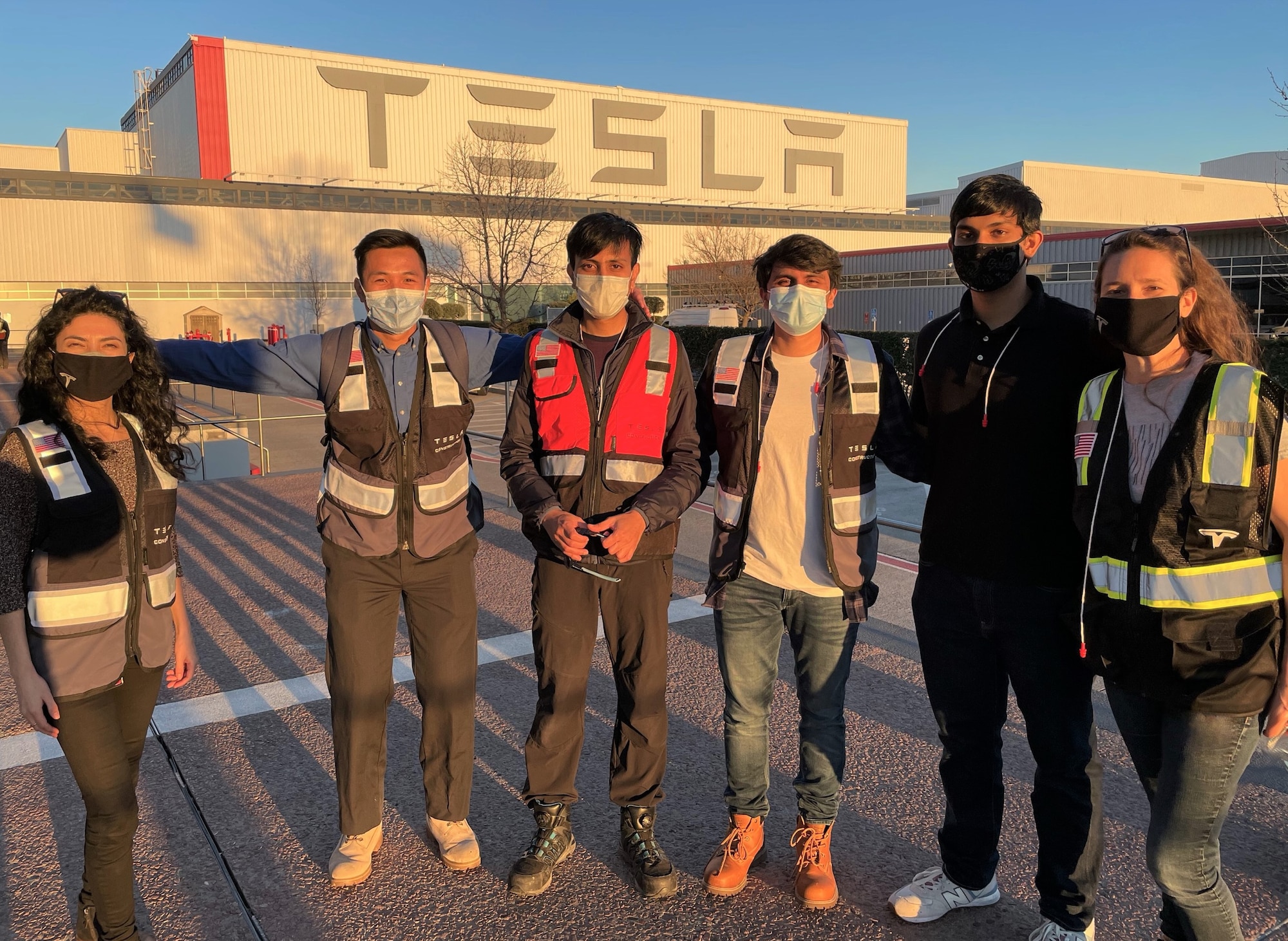 Maj. Joelle Uribe in a group photo with Tesla employees.