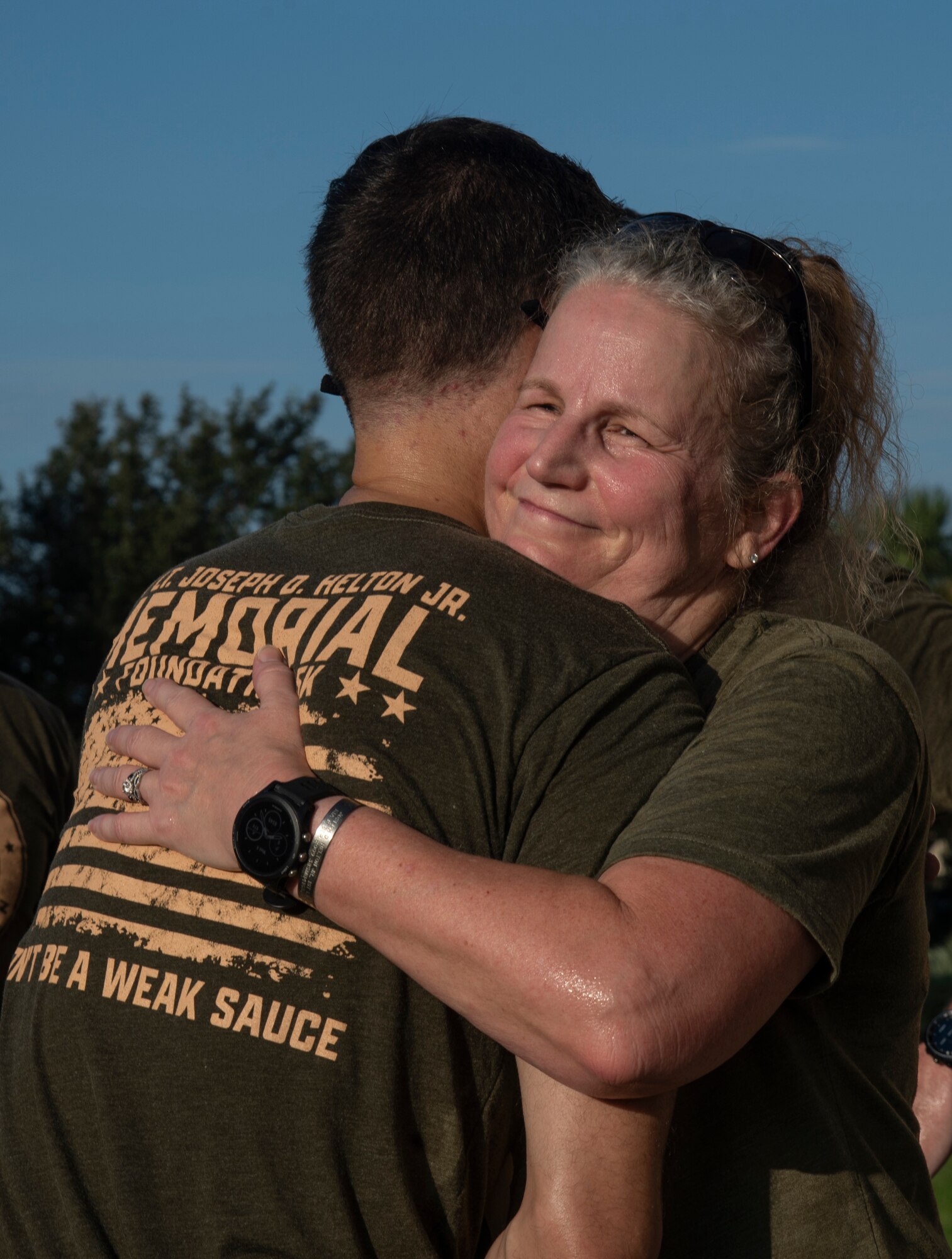 Jiffy Helton embraces a service member at the 12th annual Helton Hall 5K at MacDill Air Force Base, Florida, Sept. 8, 2021.