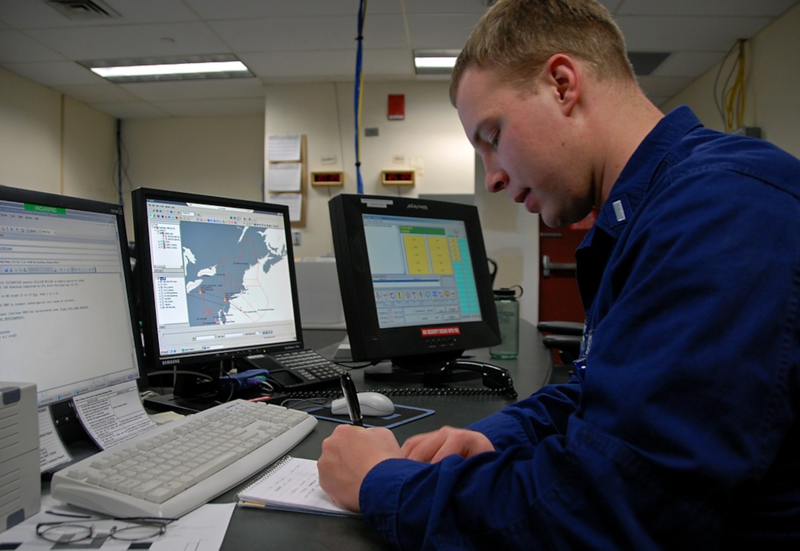 Lt. j.g. Andrew Madjeska gathers information during a routine twelve-hour watch period in the Coast Guard First District Command Center here Wednesday, March 5, 2008. Madjeska is one of three watch standers in the command center responsible for coordinating search and rescue operations and daily missions off the coast of Maine down to New Jersey. (Coast Guard photo/Lauren Downs)