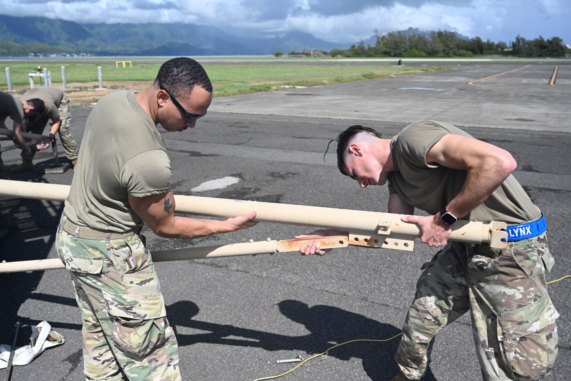 Staff Sgt. Byron Hayes and Staff Sgt. Nick Licata, 432nd Aircraft Communications Maintenance Squadron MQ-9 Reaper ground control station supervisors, assemble a ground data terminal during Exercise Agile Combat Employment Reaper Sept. 9, 2021, on Marine Corps Base Hawaii, Hawaii. The ground data terminal is part of a system used to control the MQ-9. (U.S. Air Force photo by Airman 1st Class Adrian Salazar)