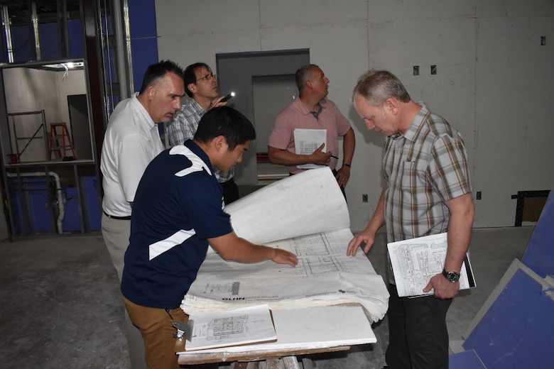 Douglas Kohns, wearing a white shirt in the photo above, and his team conduct architectural assessments of the Guam Memorial Hospital. Kohns has been named the USACE Architect of the Year for 2021.
