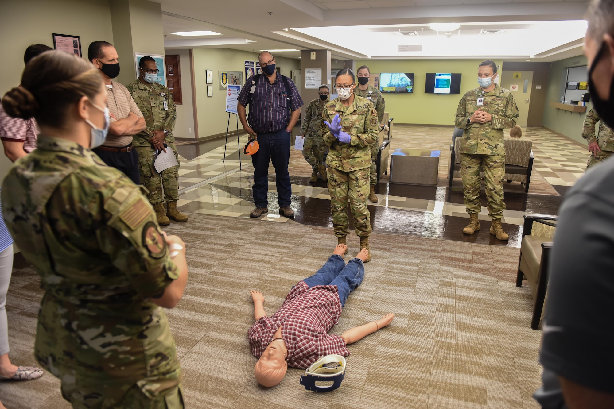 U.S. Air Force Staff Sgt. Katlyn Gorgus, foreground, and Airman 1st Class Ashleigh Chambers, center, both 97th Primary Care Flight aerospace medical technicians, show honorary commanders proper first aid procedures at Altus Air Force Base, Oklahoma, Sept .17, 2021. The 97th Primary Care Flight is responsible for the majority of primary care in the medical group and is divided into the Family Health, Pediatrics, Allergy and Immunizations Sections. (U.S. Air Force photo by 2nd Lt Cameron Silver)