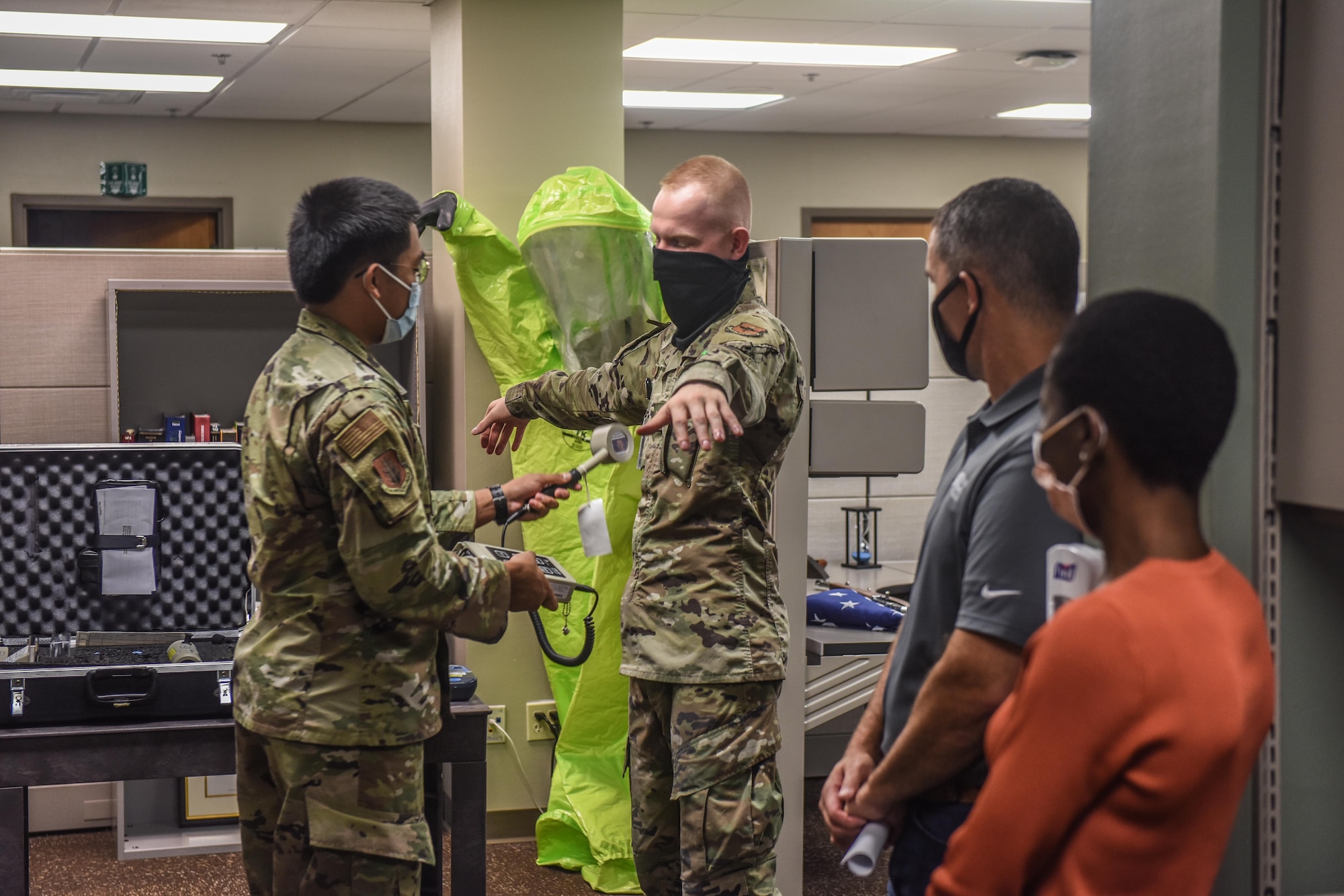 U.S. Air Force Airman 1st Class Angelo Dela Cruz, left, and Airman 1st Class Aidan Boterenbrood, right, both 97th Bioenvironmental Engineering Flight bioenvironmental engineering specialists, demonstrate to honorary commanders how they detect radiation at Altus Air Force Base, Oklahoma, Sept .17, 2021. The 97th Bioenvironmental Engineering Flight monitors 46 industrial shops, analyzes the drinking water quality, and manages the base radiation, electro and magnetic fields, and laser safety programs. (U.S. Air Force photo by 2nd Lt Cameron Silver)