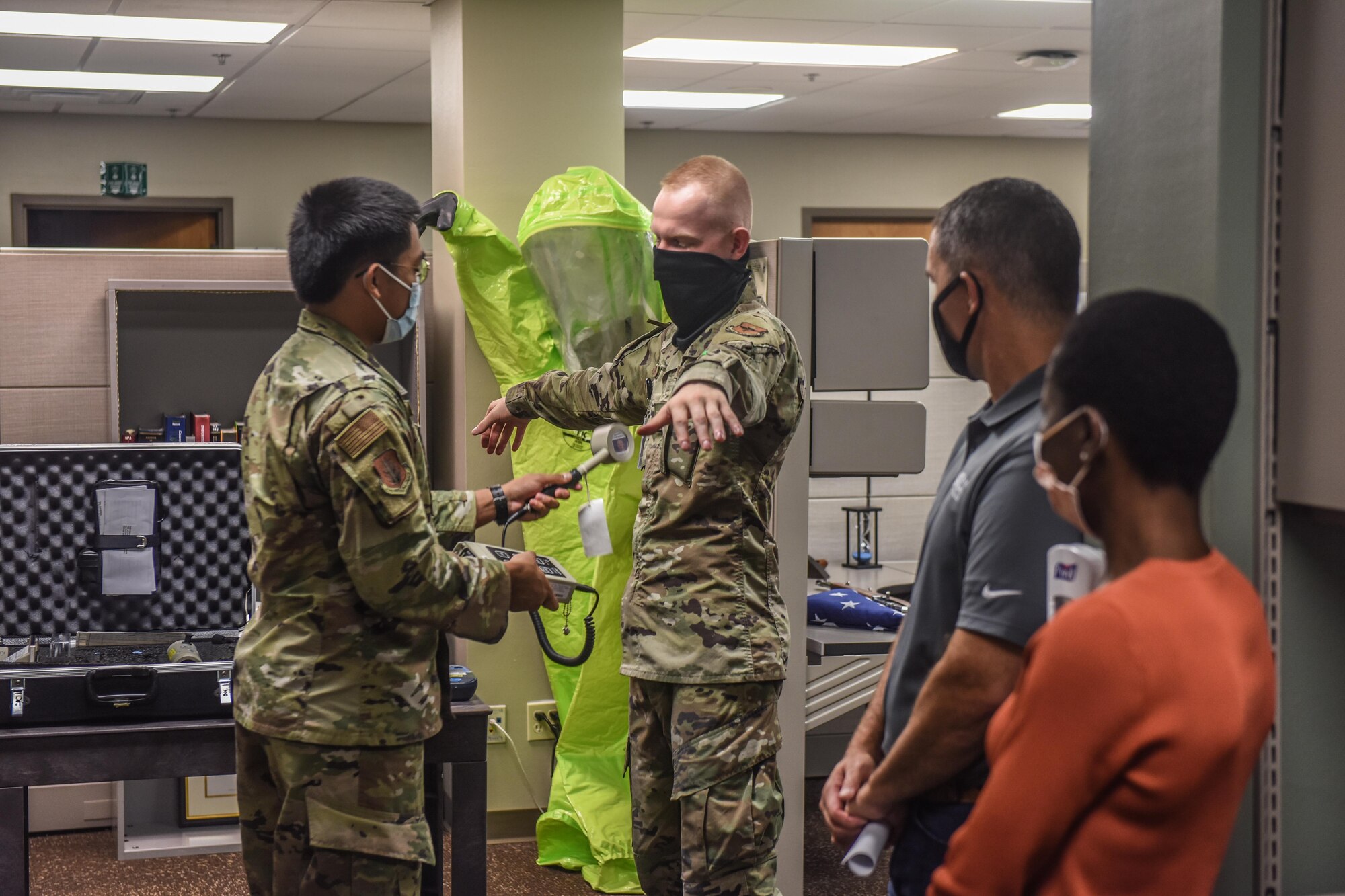 U.S. Air Force Airman 1st Class Angelo Dela Cruz, left, and Airman 1st Class Aidan Boterenbrood, right, both 97th Bioenvironmental Engineering Flight bioenvironmental engineering specialists, demonstrate to honorary commanders how they detect radiation at Altus Air Force Base, Oklahoma, Sept .17, 2021. The 97th Bioenvironmental Engineering Flight monitors 46 industrial shops, analyzes the drinking water quality, and manages the base radiation, electro and magnetic fields, and laser safety programs. (U.S. Air Force photo by 2nd Lt Cameron Silver)