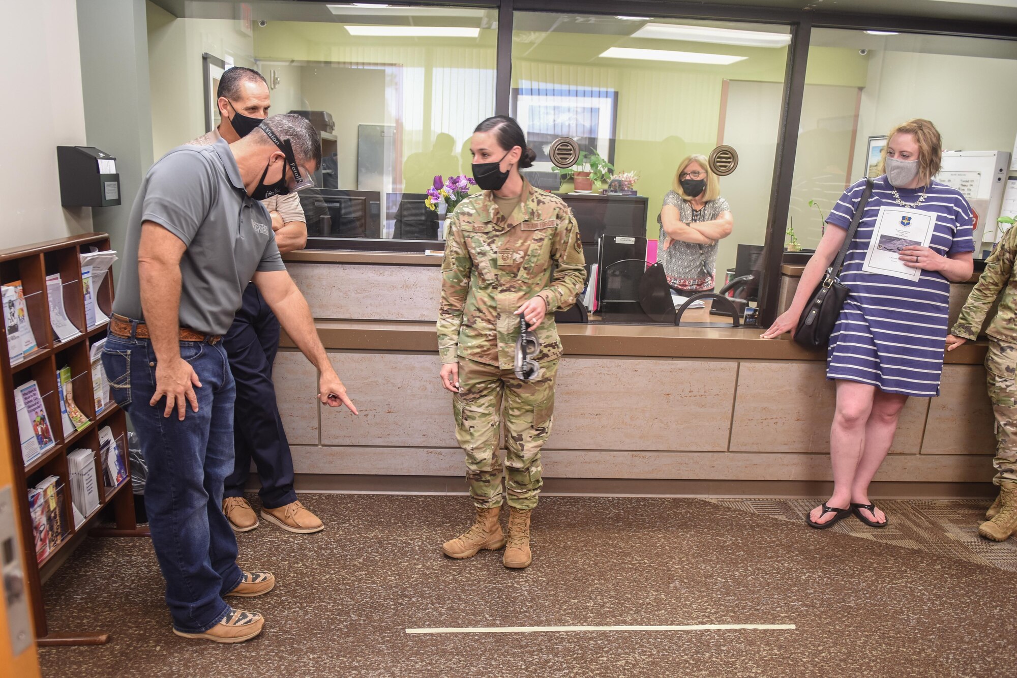 Dr. Chad Wiginton, 97th Healthcare Operations Squadron honorary commander, attempts to identify a taped line to U.S. Air Force Tech. Sgt. Delena Ruiz, 97th Mental Health Flight supervisor, while wearing “drunk goggles” at the Mental Health Clinic at Altus Air Force Base, Oklahoma, Sept. 17, 2021. The honorary commanders learned about the assessment, treatment and education provided by the 97th Mental Health Flight on a wide range of psychological and emotional issues as well as how they manage the Family Advocacy Program and Alcohol and Drug Abuse Prevention and Treatment Program. (U.S. Air Force photo by 2nd Lt Cameron Silver)