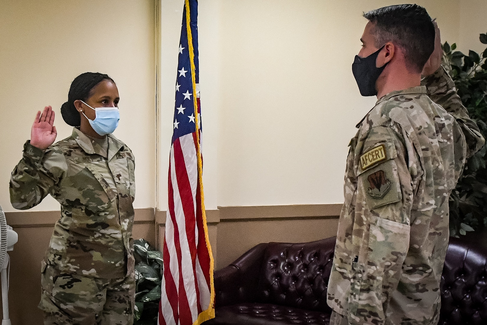 Service member taking the Oath of Enlistment being given to them by military officer.