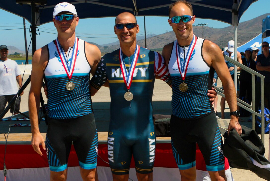 Podium finishers of the Masters Division during the 2021 Armed Forces Triathlon Championship held from 8-12 September.  Left to right:  Lt. Col. Jon Mason, Ft. Bragg, N.C.; Capt. Gene Severtson, Washington Navy Yard, D.C.; Lt. Col. Brian Hans, Wright-Patterson AFB, Ohio.  Service members from the Marine Corps, Navy (with Coast Guard) personnel), and Air Force (with Space Force personnel) compete for gold.  (Department of Defense Photo, Released)