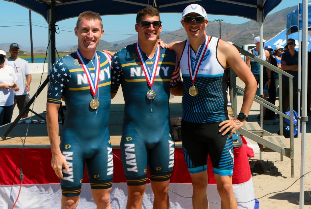 Pictured left to right are the top three finishers of the Armed Forces Men's Elite Division Triathlon Championship:  Lt. Cmdr. Kyle Hooker, NAS Jacksonville, Fla.; Ensign Adam Estroff, US Naval Academy, Md.; Capt. Joel Bischoff, Creech AFB, Nev.  The 2021 Armed Forces Triathlon Championship held from 8-12 September.  Service members from the Marine Corps, Navy (with Coast Guard) personnel), and Air Force (with Space Force personnel) compete for gold.  (Department of Defense Photo, Released)