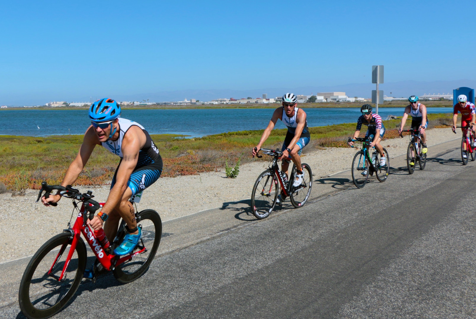 Air Force Lt. Col. Jonathan Mason of Fort Bragg, N.C. leads the pack (left) at the 2021 Armed Forces Triathlon Championship held from 8-12 September.  Service members from the Marine Corps, Navy (with Coast Guard) personnel), and Air Force (with Space Force personnel) compete for gold.  (Department of Defense Photo, Released)