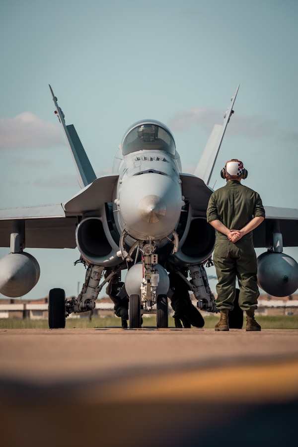 Marines with Marine Fighter Attack Squadron 112 (VMFA-112), Marine Aircraft Group 41, 4th Marine Aircraft Wing, conduct pre-flight checks underneath an F/A-18 Hornet at Naval Air Station (NAS) Joint Reserve Base (JRB) Fort Worth, Texas, Sept. 13, 2021. VMFA-112 departed NAS JRB Fort Worth for a six-month deployment to Iwakuni, Japan as part of the Unit Deployment Program where they will assist in maintaining peace and stability in the Indo-Pacific area of operations. (U.S. Marine Corps photo by Lance Cpl. David Intriago)