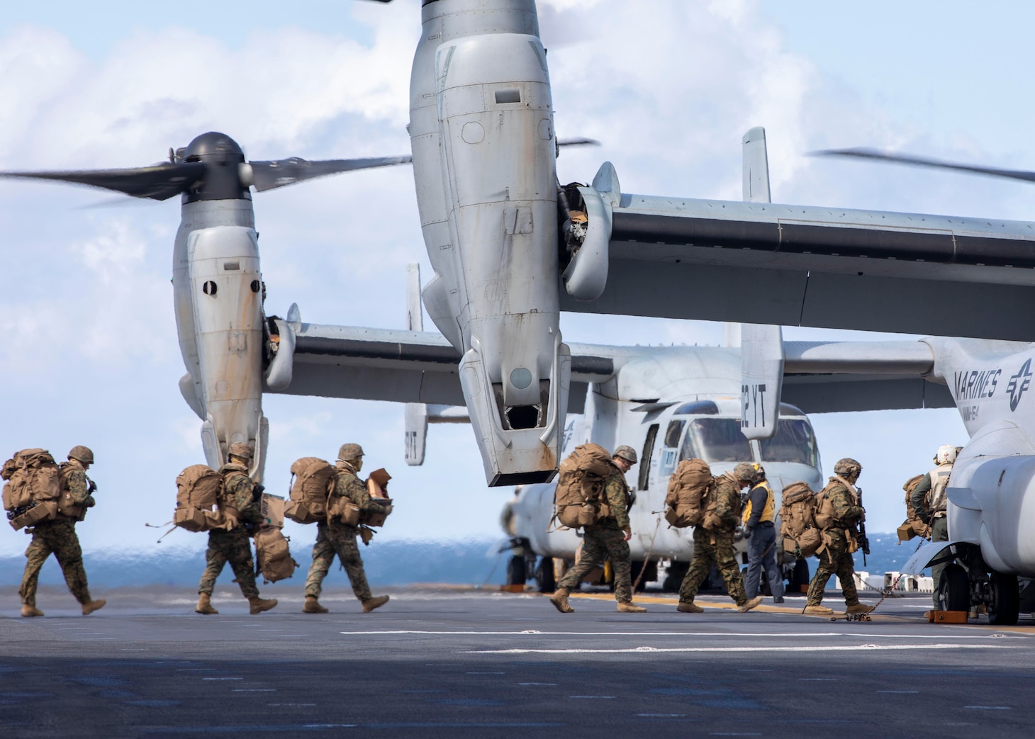 U.S. Marines with 15th Marine Expeditionary Unit board an MV-22 Osprey, assigned to Marine Medium Tiltrotor Squadron 164 (Reinforced), 15th MEU, prior to departing the amphibious assault ship USS Makin Island (LHD 8) in support of Northern Edge 2021.