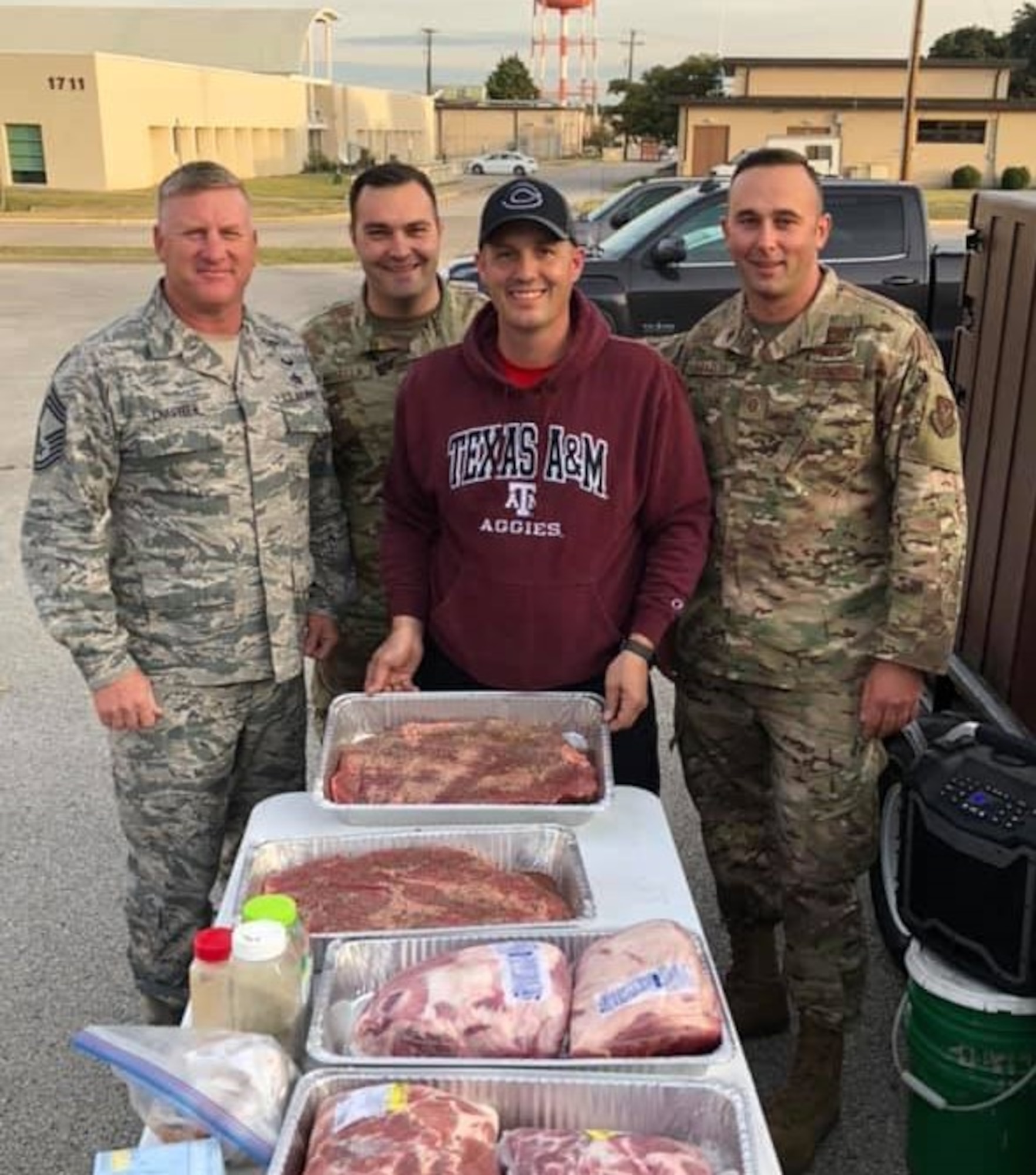 (center) Tech. Sgt. Sean Hill, 73rd Aerial Port Squadron Special Handling Supervisor, and company prepares BBQ for 73d APS family members during the unit’s family day on November 2019 at Naval Air Station Joint Reserve Base Fort Worth, Texas. During this event, more than 100 members unit members and their families would be served BBQ. Duty, family, civilian employer is the balance of the Reserve Citizen Airmen. (courtesy photo)