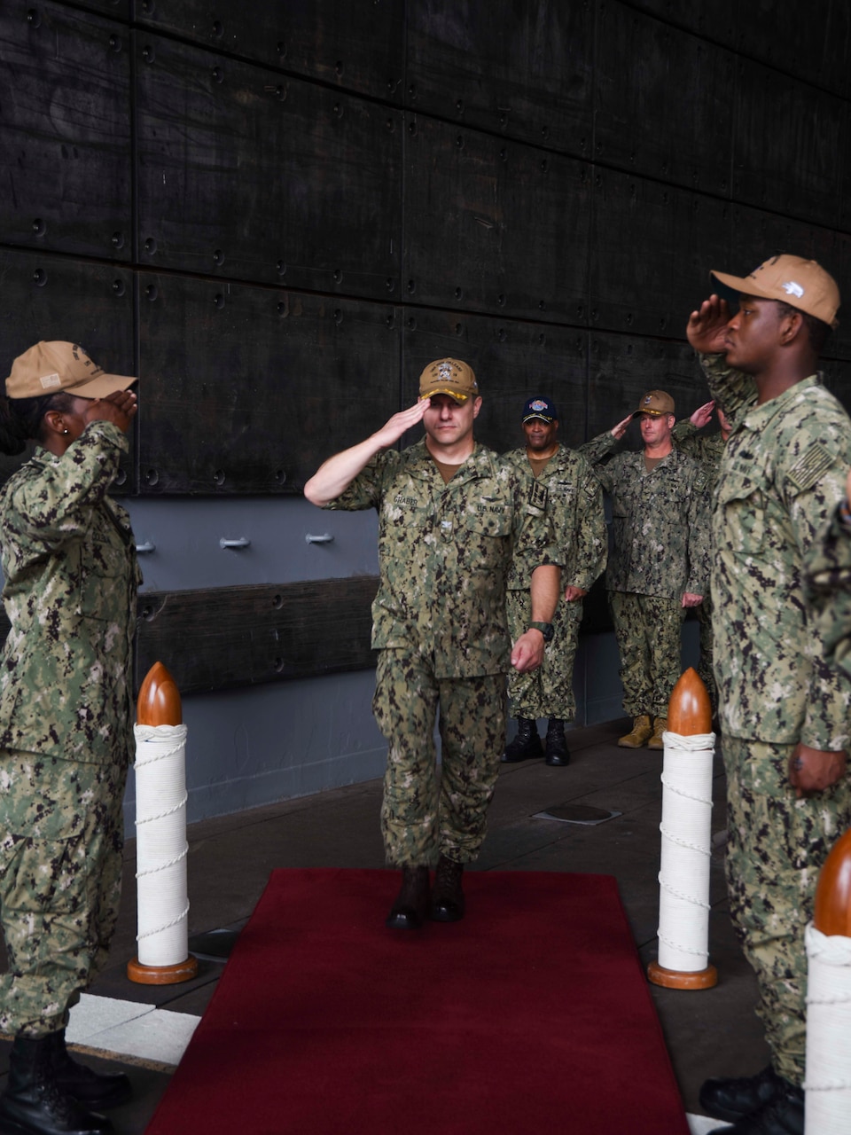 SASEBO, Japan (Sept. 23, 2021) Side boys aboard USS New Orleans (LPD 18) render honors to Capt. Douglas Graber, commanding officer of USS New Orleans, during his change of command ceremony. New Orleans, part of the America Expeditionary Strike Group, is operating in the U.S. New Orleans, part of the America Expeditionary Strike Group, along with the 31st Marine Expeditionary Unit, is operating in the U.S. 7th Fleet area of responsibility to enhance interoperability with allies and partners and serve as a ready response force to defend peace and stability in the Indo-Pacific region.