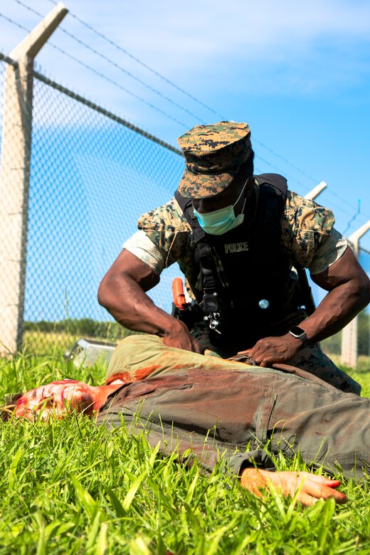 U.S. Marine Corps Cpl. Jason Joseph, above, a military police officer with the Marine Corps Air Station (MCAS) Futenma Provost Marshal Office, Marine Corps Installations Pacific – Marine Corps Base Camp Butler, triages a simulated casualty during an aircraft mishap drill near Gate 3 of MCAS Futenma, Okinawa, Japan, Sept. 21, 2021. The scenario was the signature event of Constant Vigilance 2021 on the air station and served to ensure MCAS Futenma and its personnel are able to respond to crises at a moment's notice. (U.S. Marine Corps photo by Cpl. Ryan H. Pulliam)