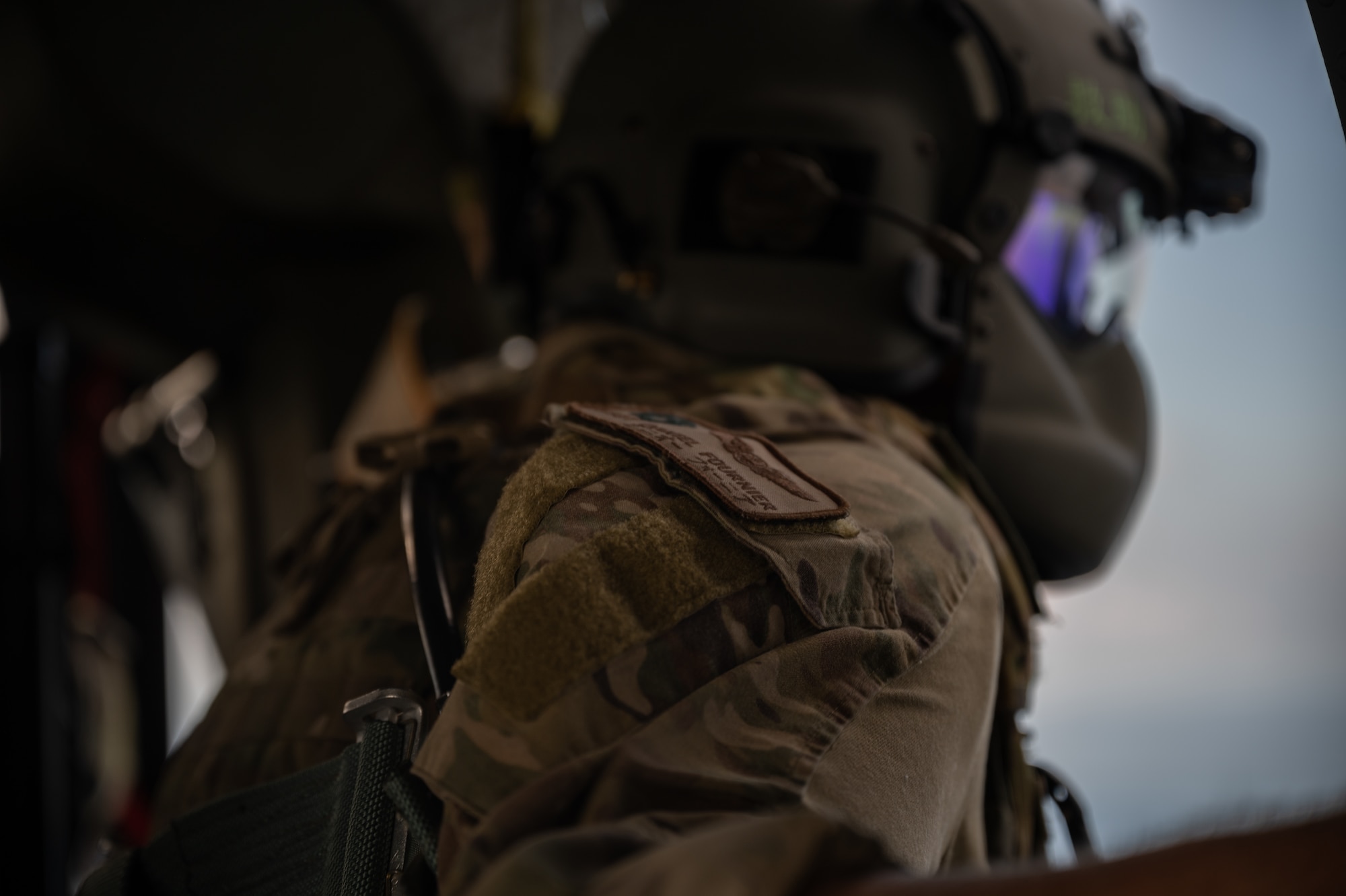 U.S. Staff Sgt. Daniel Fournier, 33rd Rescue Squadron special missions aviator, looks out of an HH-60 Pavehawk helicopter while flying over Okinawa, Japan, Sept. 23, 2021. Part of an SMA’s job consists of relaying information about objects in the pilot’s blind spots. (U.S. Air Force photo by Airman 1st Class Stephen Pulter)
