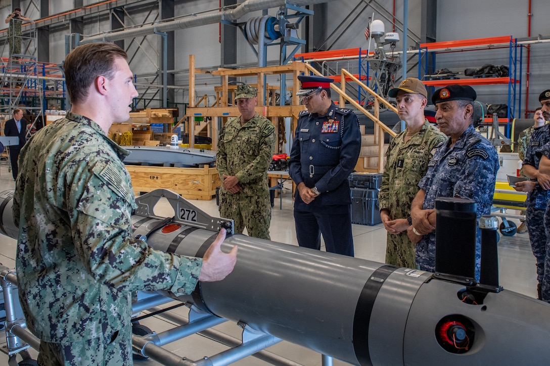 Vice Adm. Brad Cooper, commander of U.S. Naval Forces Central Command (NAVCENT), U.S. 5th Fleet and Combined Maritime Forces, center right, along with Major Gen. Ala Abdulla Seyadi, commander of the Bahrain Coast Guard, center left; and Rear Adm. Mohammed Yousif Al Asam, commander of the Royal Bahrain Naval Force, right, listen to a presentation on a Mark 18 Mod 1 unmanned underwater vehicle. During the visit, Bahraini leaders committed to partnering with NAVCENT to accelerate integration of new unmanned systems into regional maritime operations.