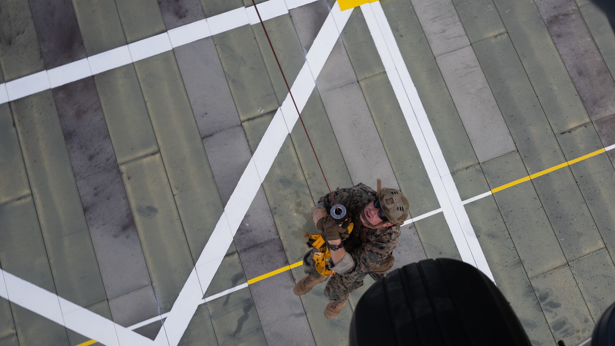 A U.S. Marine from the 3rd Reconnaissance Battalion gets hoisted up to a 33rd Rescue Squadron HH-60 Pavehawk helicopter at Camp Gonsalves, Japan, Sept. 23, 2021. This training allowed both units to conduct safe, effective and efficient hoist operations. (U.S. Air Force photo by Airman 1st Class Stephen Pulter)