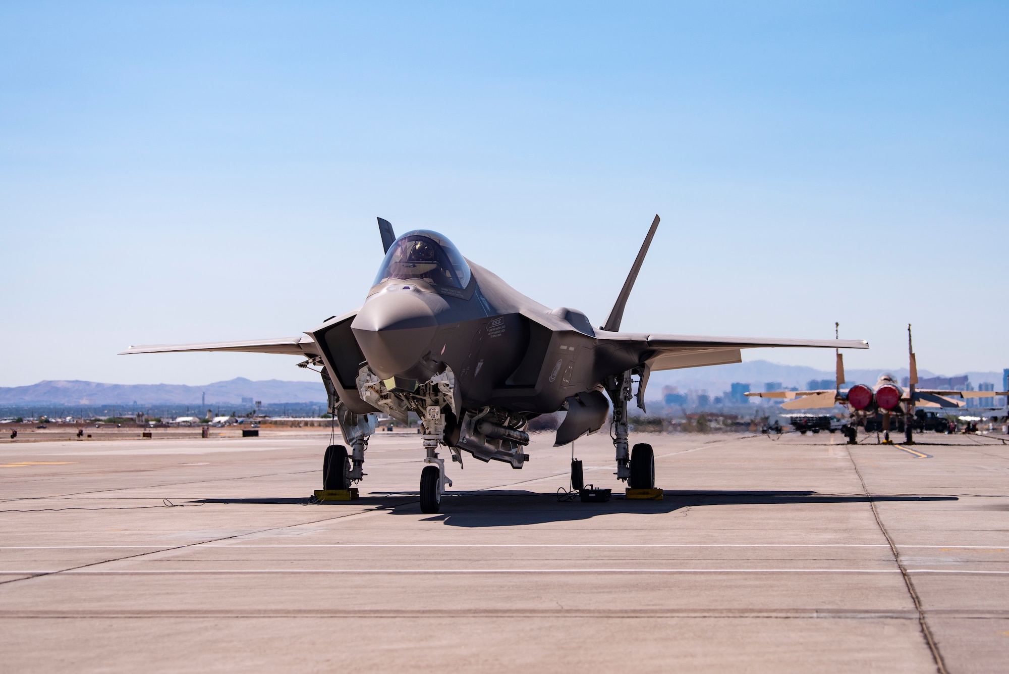 An F-35A Lighting II from Hill Air Force Base, Utah, carrying a B61-12 Joint Test Assembly sits on the flight line at Nellis Air Force Base, Nevada, Sept. 21, 2021. Two F-35A Lightning II aircraft released B61-12 Joint Test Assemblies during the first Full Weapon System Demonstration, completing the final flight test exercise of the nuclear design certification process. (U.S. Air Force photo by Airman 1st Class Zachary Rufus)