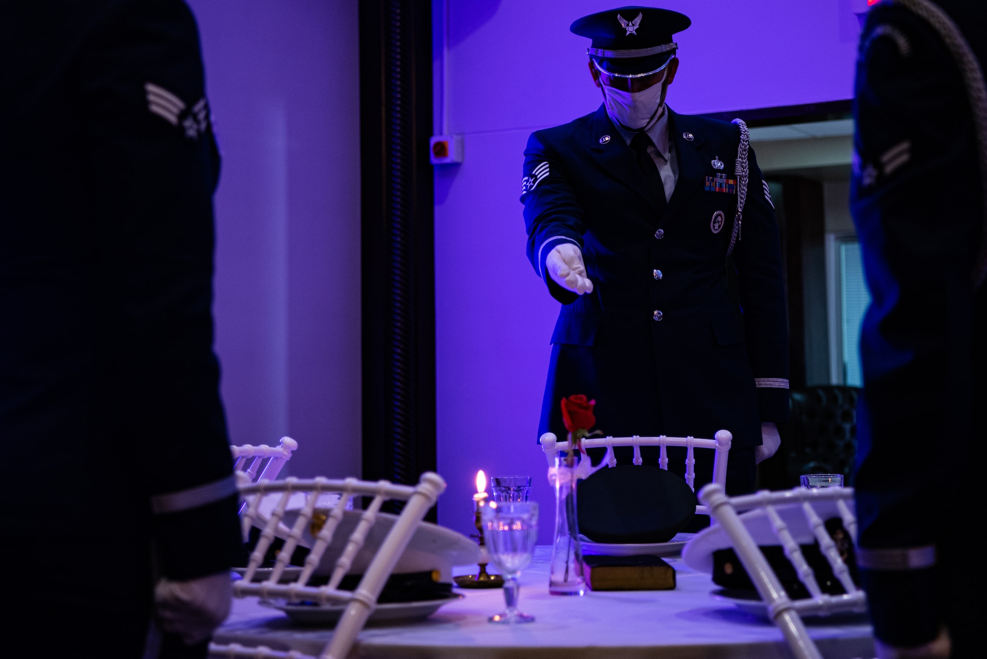 Honor guardsmen performing a ceremony at POW/MIA table
