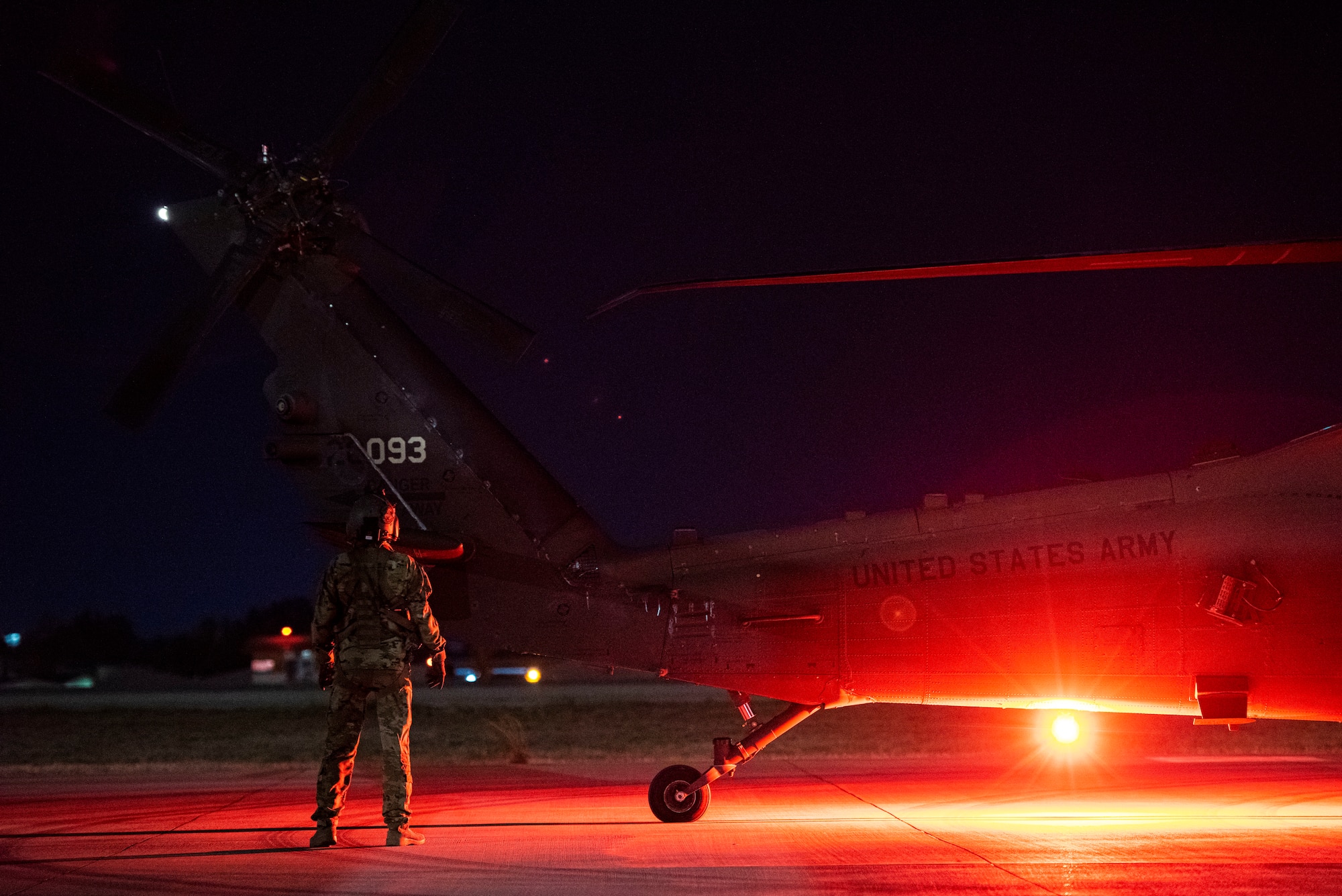 U.S. Army soldier assigned to Task Force Black Cat inspects a UH-60 Black Hawk