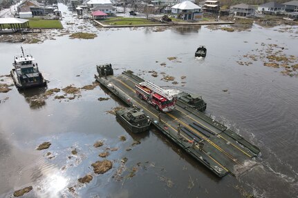 Louisiana National Guard members with the 2225th Multi-Role Bridge Company ferry emergency responders and equipment from Lafitte to Barataria to assist locals with recovery efforts, Jean Lafitte, La., Sept. 4, 2021. The only bridge to Barataria was damaged during Hurricane Ida and was rendered inoperable.