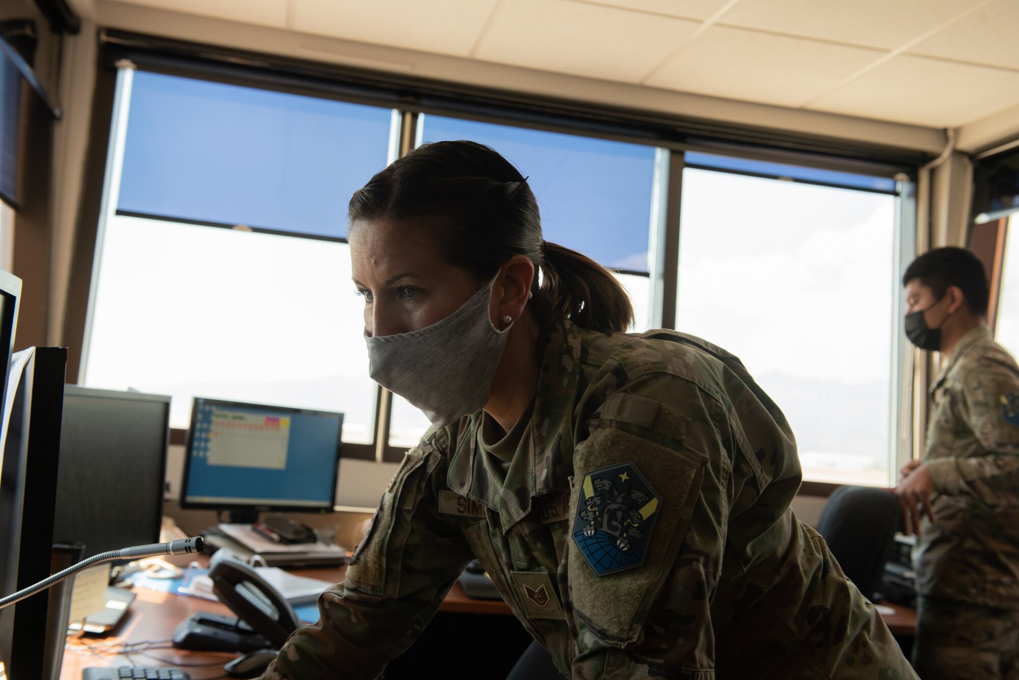 Airman looks at the screen in the base ops building