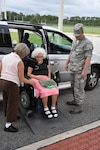 Florida Air National Guardsmen from the 125th Fighter Wing assist citizens with special needs into a special needs shelter opened at the Atlantic Coast High School in Jacksonville, Florida Sept. 9, 2017. The shelter is one of 11 opened in Duval County to protect citizens from Hurricane Irma. (Air National Guard photo by Master Sgt. William Buchanan/Released)