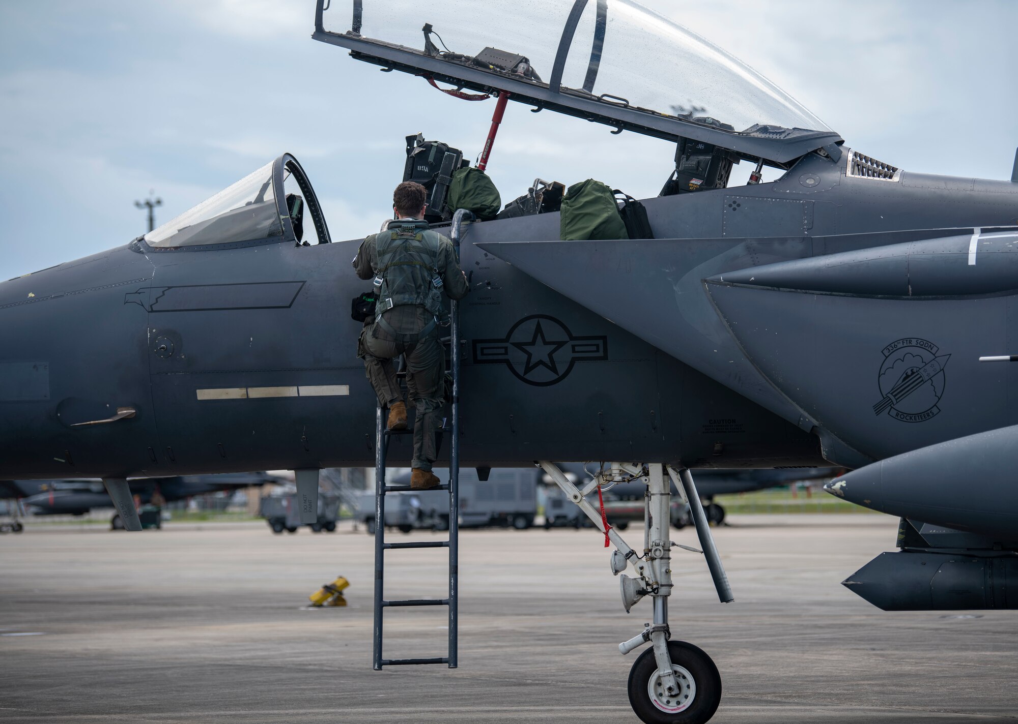 Man climbing into a fighter jet