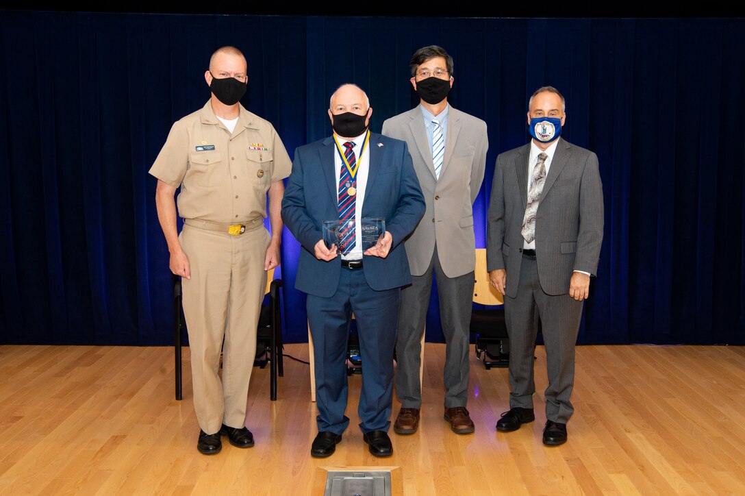 Naval Surface Warfare Center, Carderock Division Commanding Officer Capt. Todd E. Hutchison, Signatures Department Head Paul Shang and Technical Director Larry Tarasek present the Dr. Murray Strasberg Award.