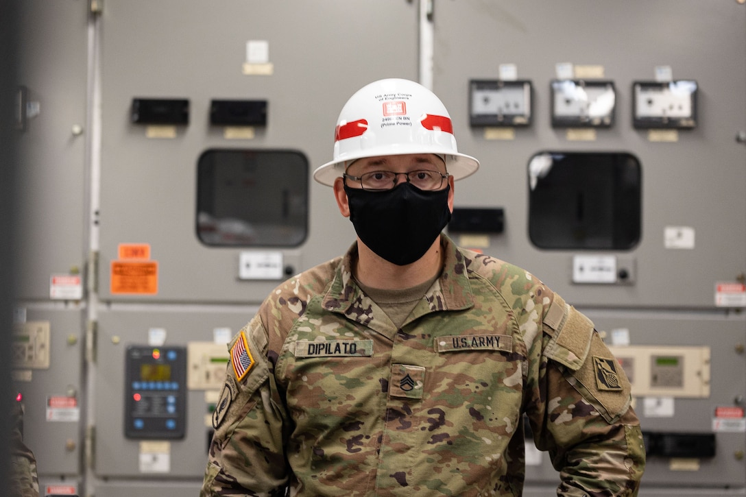 U.S. Army Staff Sgt. Daniel Dipilato, 249th Engineer Battalion Charlie Company Prime Power production specialist, assesses components in an electrical room as part of an evaluation during Exercise Empire Rising 2021 at the U.S. Naval Academy in Annapolis, Md., July 13, 2021. The 249th EB provides commercial-level power to military units and federal relief organizations during full-spectrum operations. It’s charged with the rapid provision of Army generators to support worldwide requirements. (U.S. Army photo by Greg Nash)