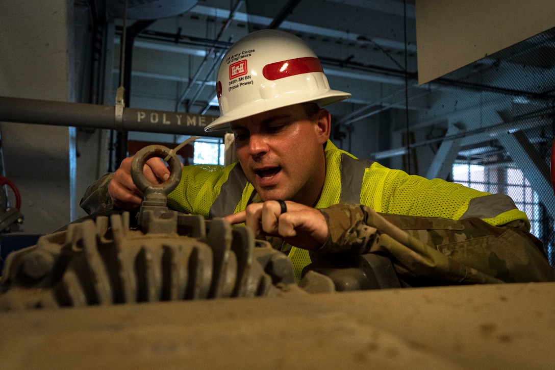 U.S. Army Sgt. Nathan Holmes, 249th Engineer Battalion Charlie Company Prime Power production specialist, relays facility data to fellow soldiers during Exercise Empire Rising 2021 at the Washington Aqueduct in Washington D.C., July 14, 2021. The 249th EB provides technical expertise and performs assessments to determine generator requirements at facilities as well the connection materials required at critical public facilities during emergencies. (U.S. Army photo by Greg Nash)