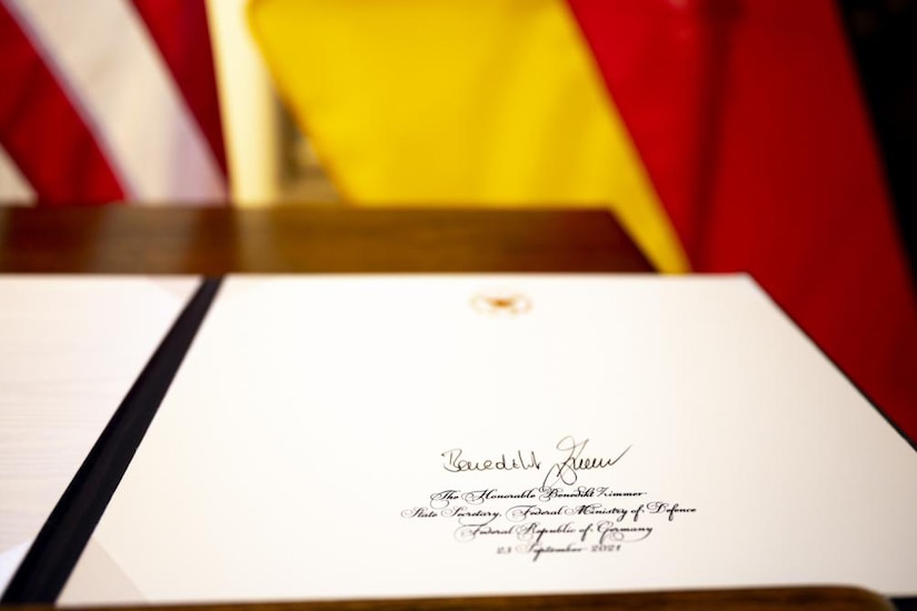 A folder with a signature sits on a table.