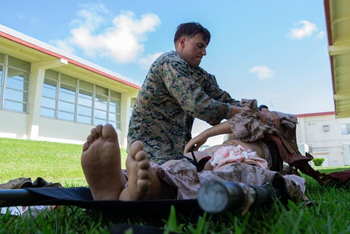 U.S. Marine Corps Sgt. Alexander Koeneke, an explosive ordnance technician with Explosive Ordnance Company, 9th Engineer Support Battalion, 3rd Marine Logistics Group, practices Tactical Combat Causality Care on a simulated casualty during a TCCC course on Camp Hansen, Sept. 9, 2021. 9th ESB conducts TCCC classes to allow more Marines to become certified in combat lifesaving, a skill Lt. Col. Marcus Gillett, battalion commander of 9th ESB, plans for every Marine to have in the near future. 3rd MLG, based out of Okinawa, Japan, is a forward deployed combat unit that serves as III MEF’s comprehensive logistics and combat service support backbone for operations throughout the Indo-Pacific area of responsibility.