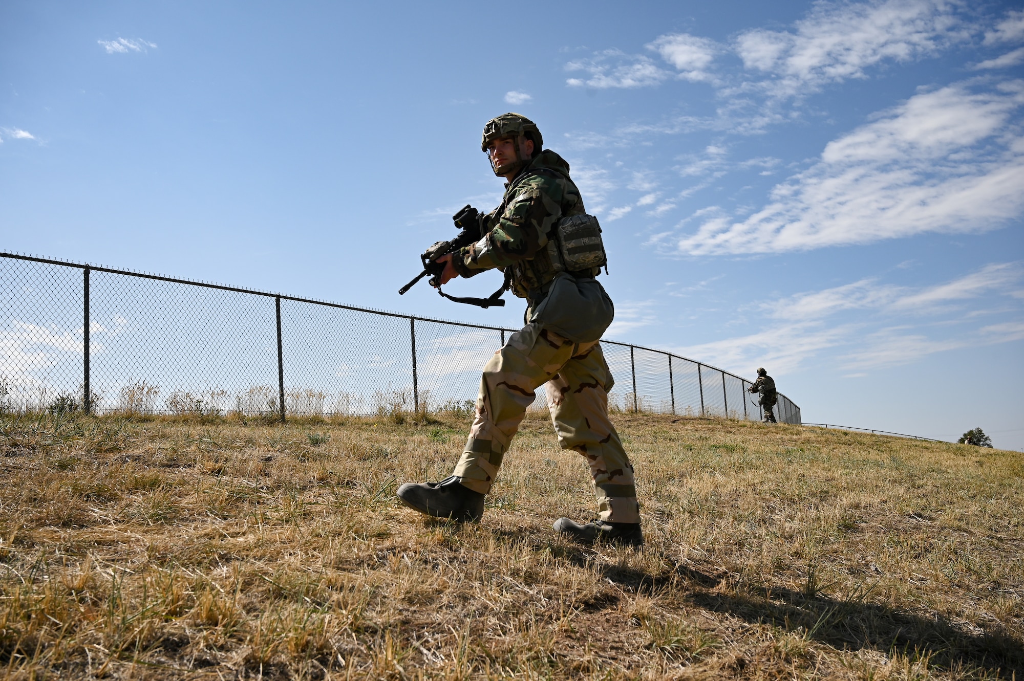 Staff Sgt. Isaac Preuss, 75th Security Forces Squadron, advances up a hill during a readiness exercise at Hill Air Force Base, Utah, Sept. 23, 2021. Squadrons from the 75th Air Base Wing participated in a phase II readiness exercise where they were assessed while performing tasks in an austere environment. (U.S. Air Force photo by R. Nial Bradshaw)