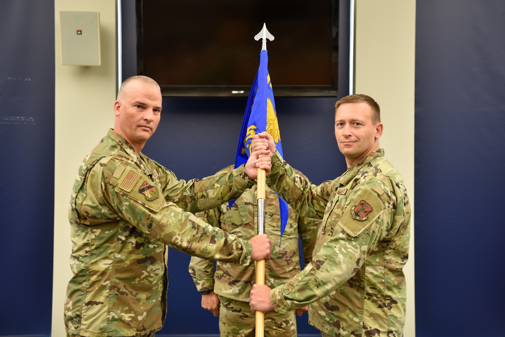 Lt Col. Aaron Gulczynski (right) receives the guidon from Col. Timothy Guy (left) during the 128th Air Refueling Wing Logistics Readiness Squadron change in command ceremony in Milwaukee, Wisconsin, Aug. 8, 2021. The Logistics Readiness Squadron provides unparalleled support to the 128 ARW refueling mission.  (U.S. Air Force photo by Senior Airman Madison Knabe)