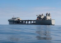 The Expeditionary Sea Base USS Hershel "Woody" Williams (ESB 4) steams ahead as Sailors assigned to Deck Department conduct small boat operations, Sept. 19, 2021.