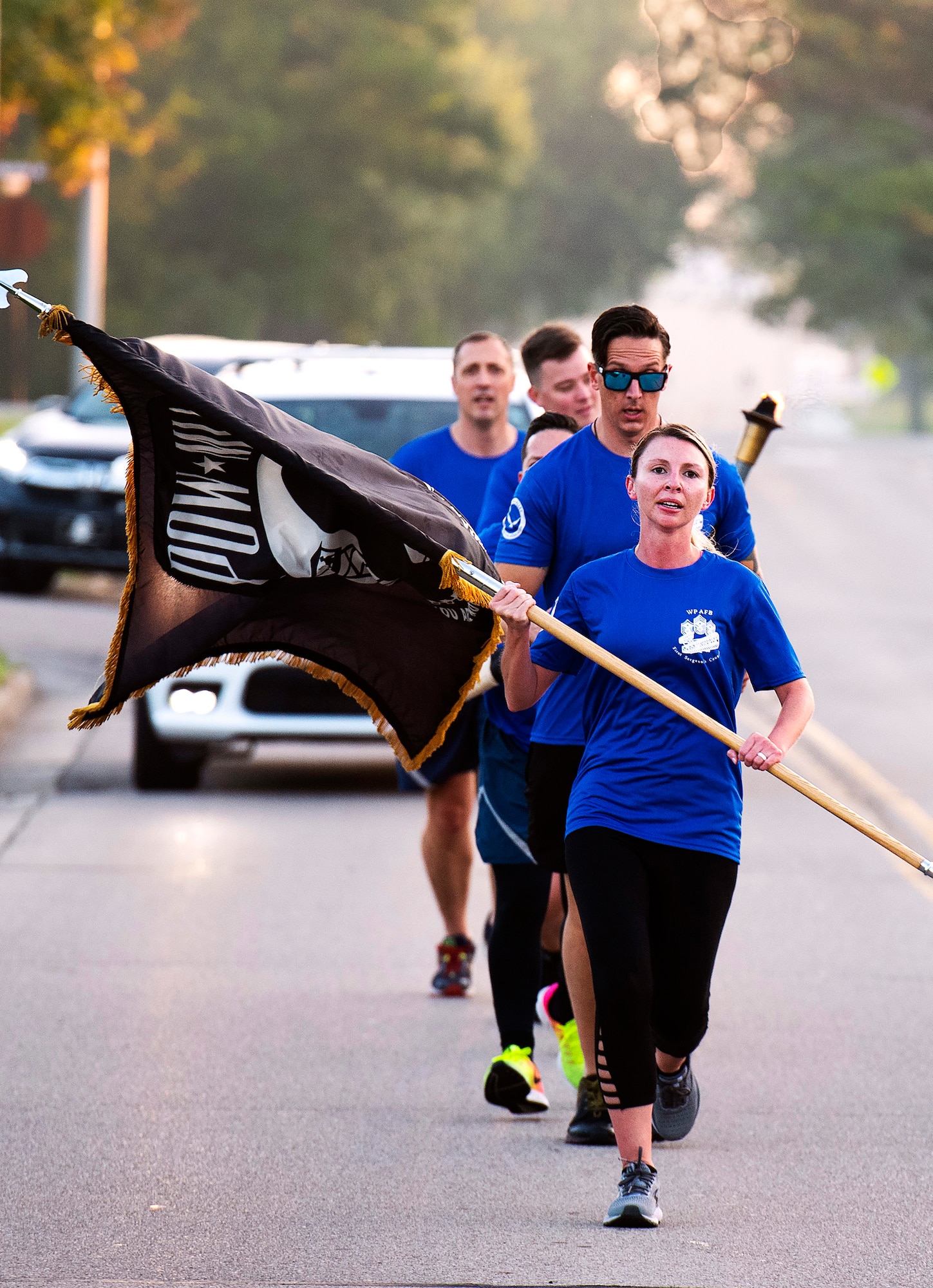 Senior Master Sgt. Elise Redziniak, Air Force Life Cycle Management Center first sergeant, leads a first sergeant delegation on the first leg of the POW/MIA run Sept. 17, 2021, at Wright-Patterson Air Force Base, Ohio. Runners carried the POW/MIA Flag, a torch and scroll over a 6.2-mile course to the base’s POW/MIA Recognition Day wreath-laying ceremony. It was in honor and remembrance of those American service members held captive or missing in action. (U.S. Air Force photo by R.J. Oriez)