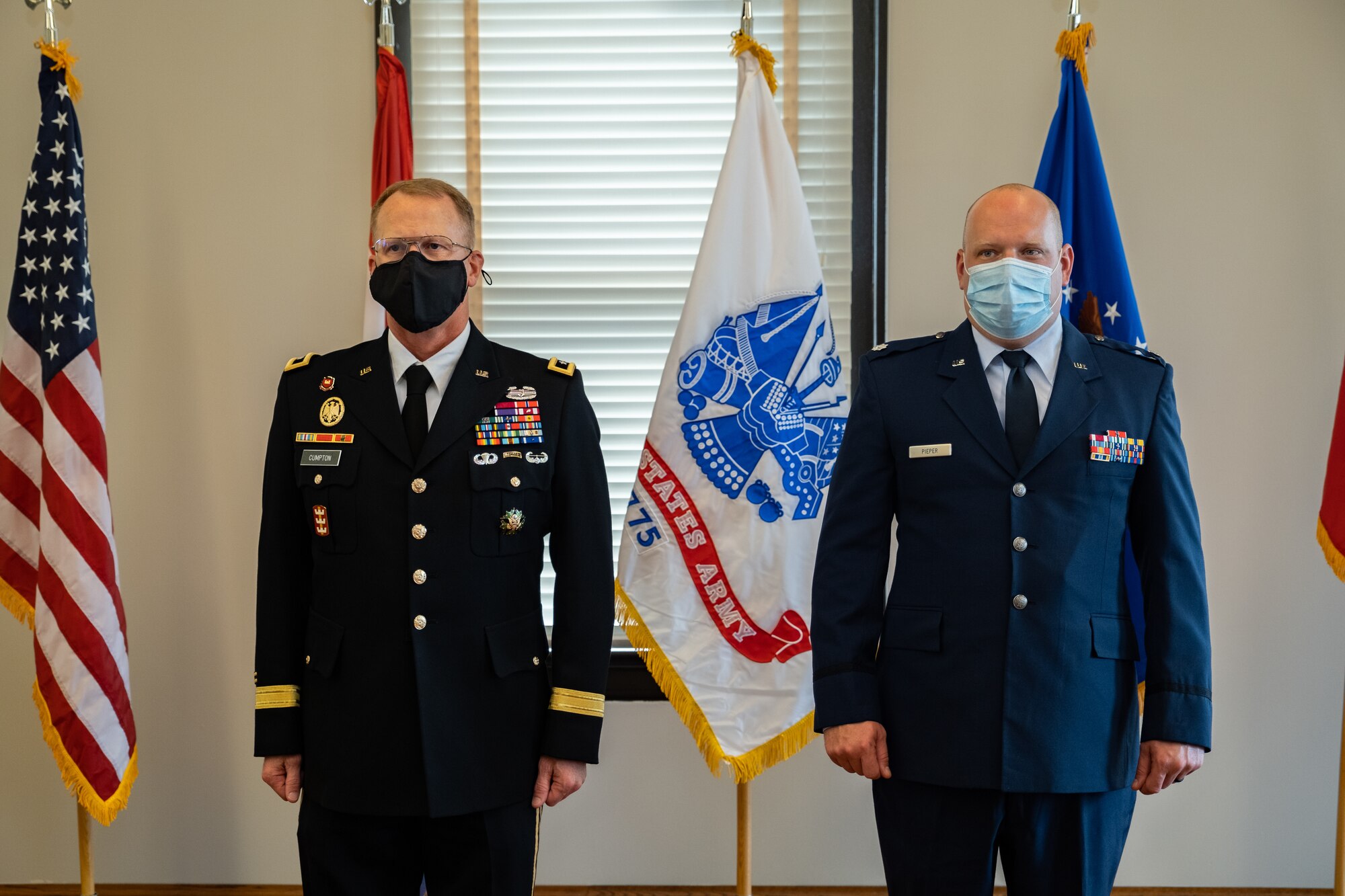 Adjutant General of the Missouri National Guard Maj. Gen. Levon Cumpton and Lt. Col. Matthew Pieper, a Center for Sustainment of Trauma and Readiness Skills instructor, stand at attention during a ceremony at Jefferson Barracks Air National Guard Base, Missouri, September 12, 2021. Pieper was presented with the Distinguished Flying Cross for his lifesaving actions during a 2018 aeromedical evacuation flight while deployed to Afghanistan. (U.S. Air National Guard photo by Master Sgt. Stephen Froeber)