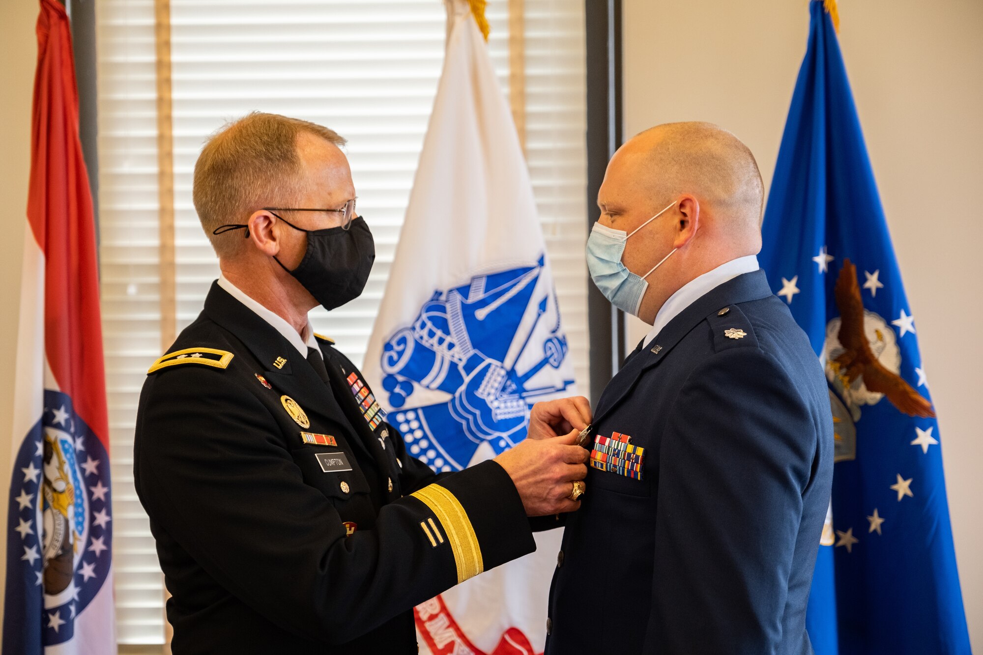 Adjutant General of the Missouri National Guard Maj. Gen. Levon Cumpton presents Lt. Col. Matthew Pieper, a Center for Sustainment of Trauma and Readiness Skills instructor, with the Distinguished Flying Cross during a ceremony at Jefferson Barracks Air National Guard Base, Missouri, September 12, 2021. Pieper was decorated for his lifesaving actions during a 2018 aeromedical evacuation flight while deployed to Afghanistan. (U.S. Air National Guard photo by Master Sgt. Stephen Froeber)