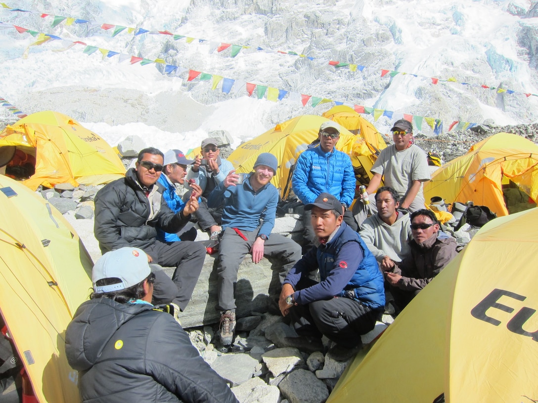 people sit around at a base camp at mount Everest