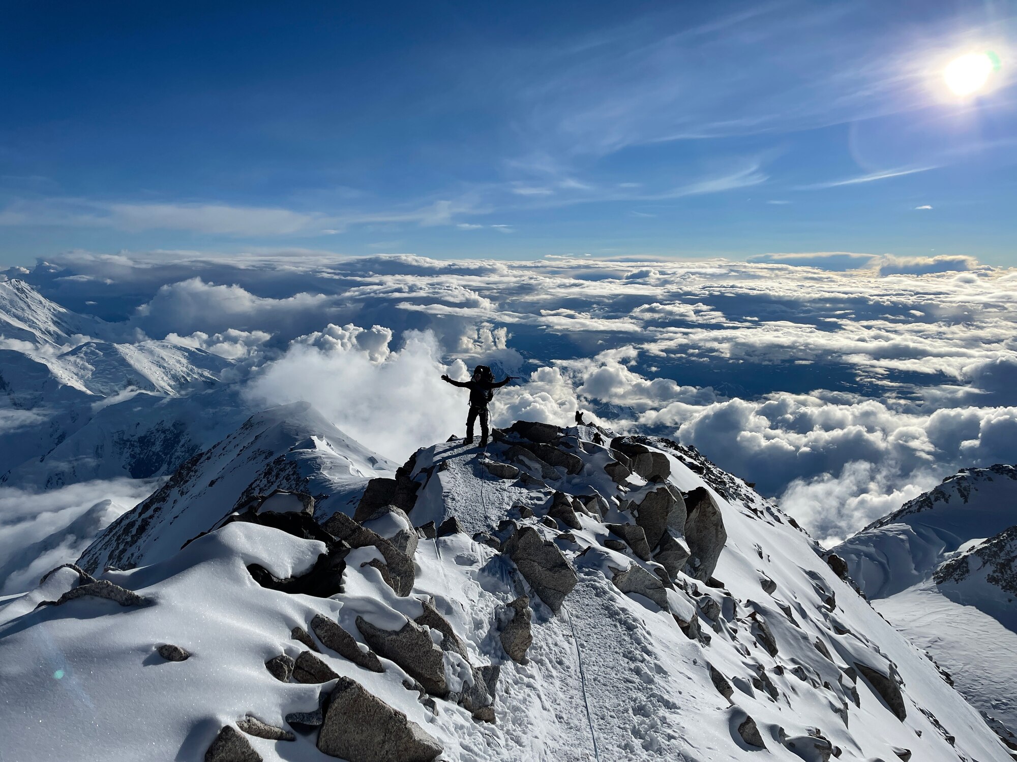 man stand on top of a mountain