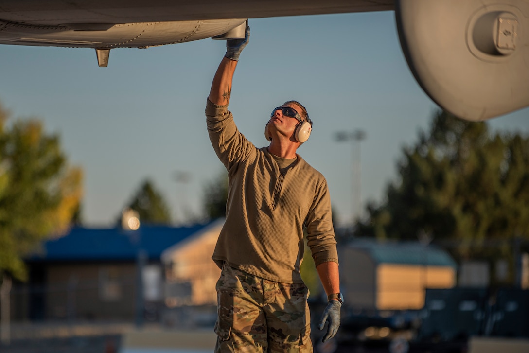 A guardsman works on an aircraft.