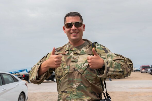 U.S. Air Force Staff Sgt. Kenneth Boyton, Task Force-Holloman Public Affairs specialist deployed from Seymour Johnson Air Force Base, North Carolina, poses for a photo Sept. 1, 2021 at Aman Omid Village in support of Operation Allies Welcome at Holloman Air Force Base, New Mexico. Boyton is tasked with documenting the ongoing TF-H mission at Holloman. The Department of Defense, through U.S. Northern Command, and in support of the Department of State and Department of Homeland Security, is providing transportation, temporary housing, medical screening, and general support for at least 50,000 Afghan evacuees at suitable facilities, in permanent or temporary structures, as quickly as possible. This initiative provides Afghan evacuees essential support at secure locations outside Afghanistan. (U.S. Army photo by Spc. Nicholas Goodman)