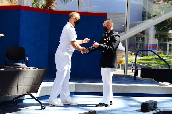 Marine 1st Lt. Michael LoGrande receives his weapons systems officer (WSO) Wings of Gold during a ceremony at the National Naval Aviation Museum at Naval Air Station Pensacola, Sept. 24, 2021.