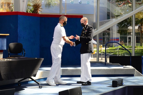 Marine 1st Lt. John Roger Rueckel III receives his weapons systems officer (WSO) Wings of Gold during a ceremony at the National Naval Aviation Museum at Naval Air Station Pensacola, Sept. 24, 2021.