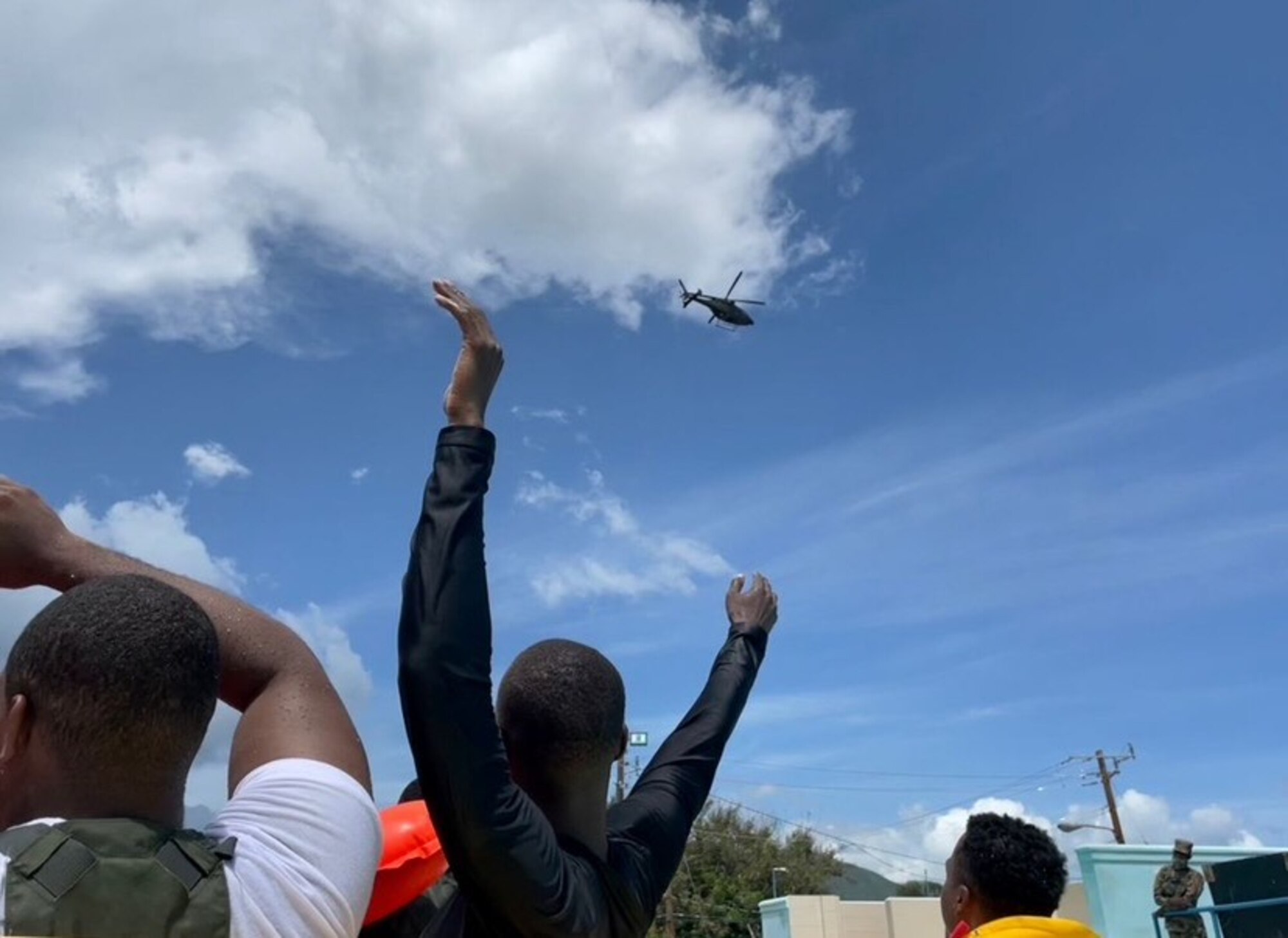 Service member waves to helicopter