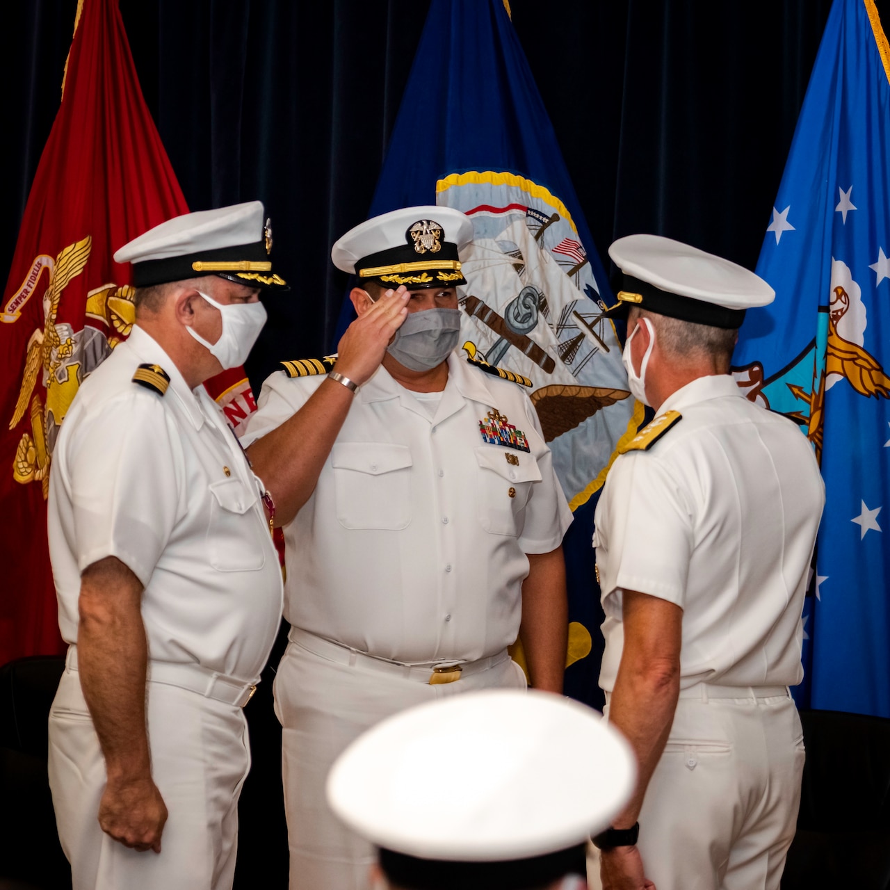 Capt. Dean Muriano, center, reports to Rear Adm. Pete Garvin, right, commander, Naval Education and Training Command (NETC), that he has relieved Capt. Keith Dowling, left, as commanding officer of the Center for Explosive Ordnance Disposal and Diving (CEODD) during a change of command ceremony, Sept. 22.
