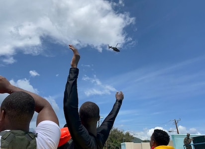 Service member waves to helicopter