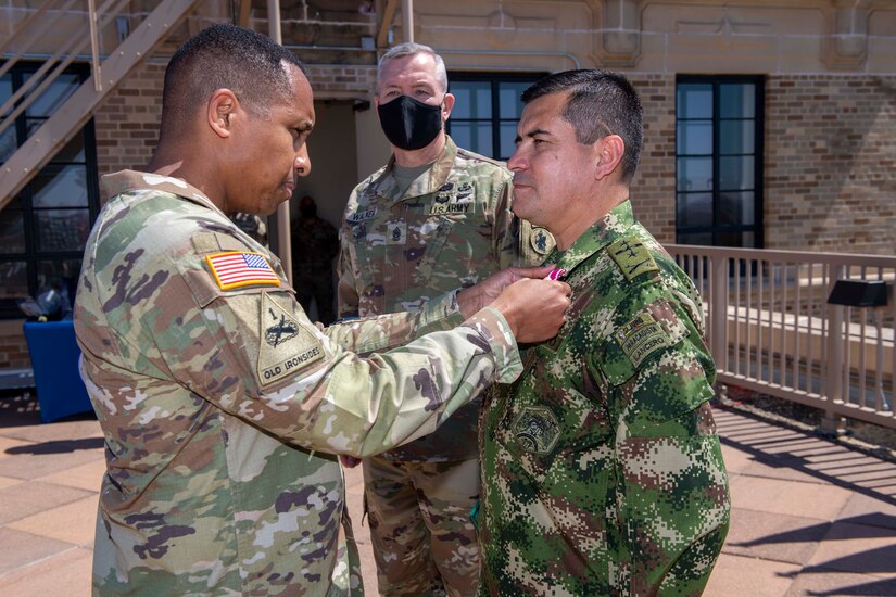 Maj. Gen. William L. Thigpen, left, U.S. Army South commanding general, recognizes Colombian Army Col. Raul Medina Valenzuela, right, the Colombian liaison officer to U.S. Army South, at the U.S. Army South headquarters Sept. 24. During a farewell ceremony, Medina was recognized for many accomplishments, as well as for his leadership skills and mission focus, which greatly strengthened the relationship between the Colombian and U.S. armies. U.S. Army South is home to five partner nation liaison officers to include Argentina, Brazil, Chile, Colombia and Peru, to assist in the coordination of security cooperation activities and increase awareness of our partner nation armies' capabilities and strengths.